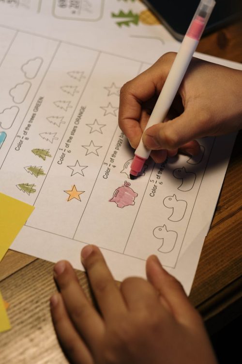 person holding a pink marker