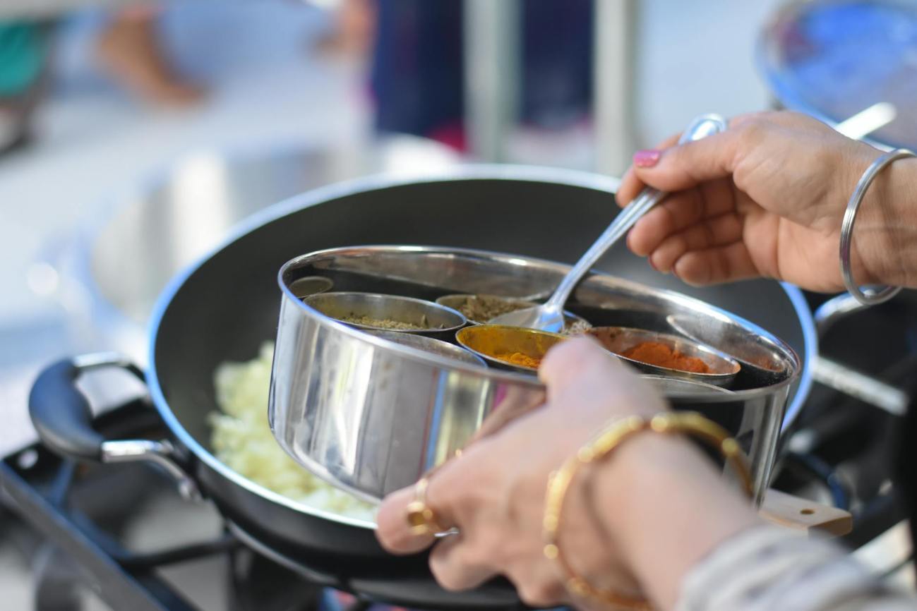 woman cooking with LPG- International Women's Day